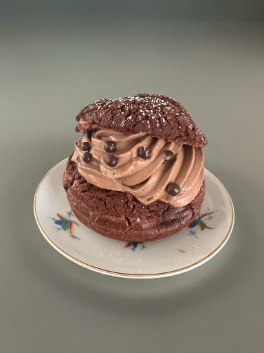 Chocolate Cream Puff Oozing with chocolate flavors with topped with chocolate pearls.